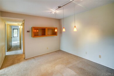 Dining room is off of kitchen with pendant lightin