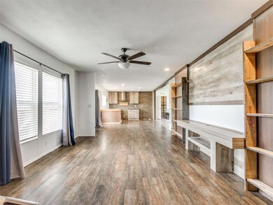 Unfurnished living room with ceiling fan, dark wood-style flooring, and recessed lighting