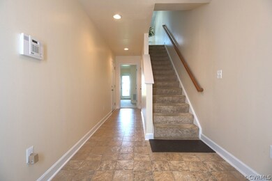 Foyer with access to garage, bedroom 2 and stairs taking you to 2nd level