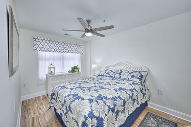 Bedroom with wood finished floors and a ceiling fan