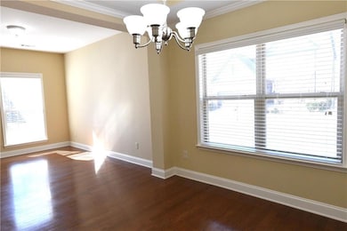 Spare room with a chandelier, dark hardwood / wood