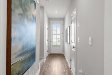 Doorway to outside featuring wood finished floors and recessed lighting