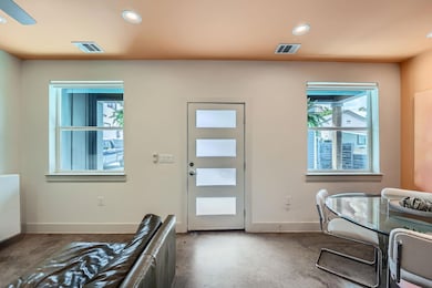 Entryway with plenty of natural light, concrete f