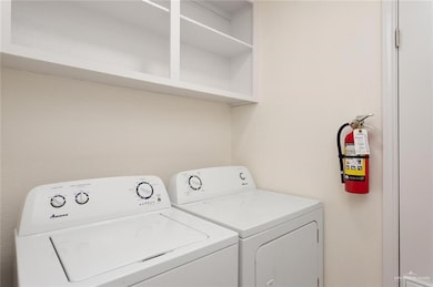 Washroom featuring washing machine and clothes dryer