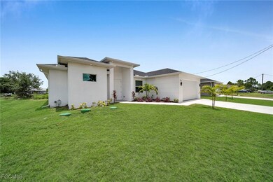 Prairie-style house featuring a front yard, concrete driveway, stucco siding, and a garage