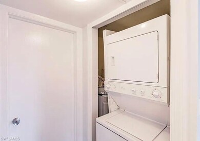 Washroom with stacked washer / drying machine