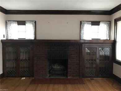 Beautiful lead glass bookcases with fireplace and mantel in living room.