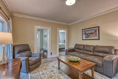 Living room looking to front entry and primary bed