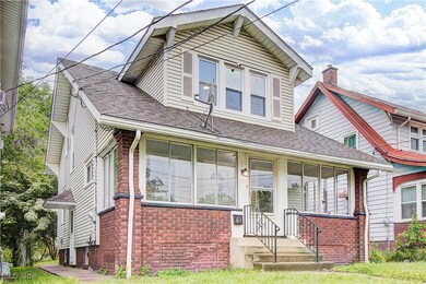 View of front of house with brick siding, a shingled roof, and entry steps