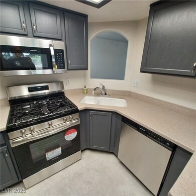 Kitchen with gray cabinetry, light countertops, a
