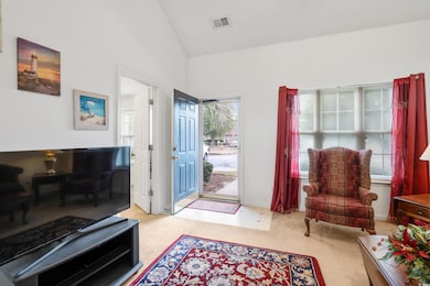 Carpeted entryway featuring a wealth of natural li