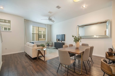 Main level dining room with dark wood floors, ceiling fan, and recessed lighting