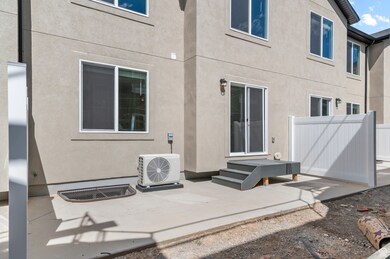 Back of house featuring a patio area and stucco siding