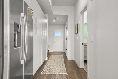 Hallway featuring dark wood finished floors and r