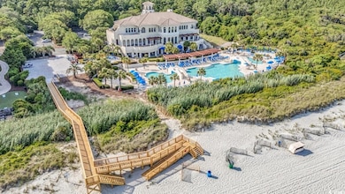 Aerial view of property and surrounding area with a pool area and a forest