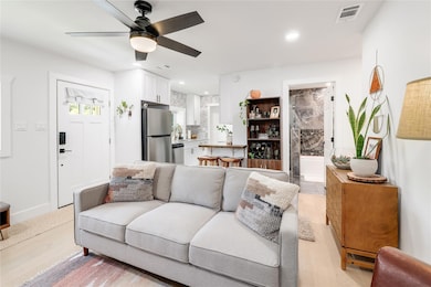 Living room featuring light wood-style floors, a 