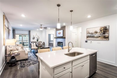 Kitchen with a tiled fireplace, dark hardwood / wo