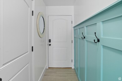Mudroom with light wood-style flooring