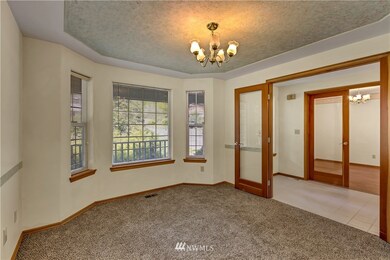 One of two rooms by the front door. Office? Bedroom?