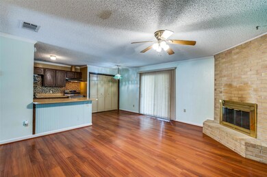Unfurnished den with a brick fireplace, wood finis