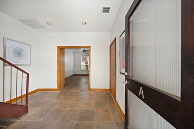 Spacious entry with slate floors, double reeded gl