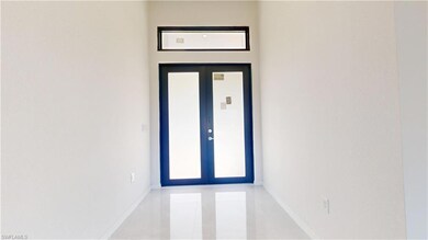 Property entrance featuring french doors
