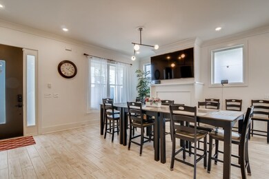 TV above Fireplace in Dining Room.