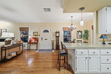 Kitchen featuring white cabinets, a chandelier, a