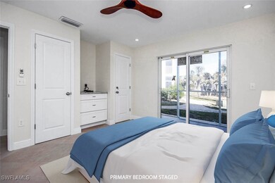 Tiled bedroom with ceiling fan and access to outsi