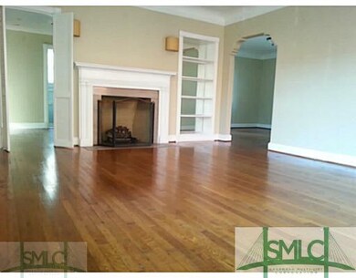 Living Room. Hardwood floors, a fireplace and a bu