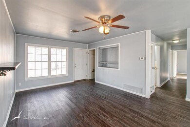 Living room with dark hardwood, wood-style floors.