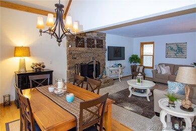 SPACIOUS DINING AND LIVING AREA WITH STONE WOOD BU
