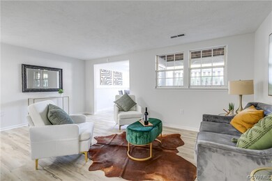 Living room with a textured ceiling and light hard