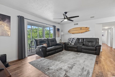 Living room featuring a textured ceiling, ceiling 