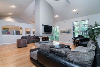 Living room featuring ceiling fan, high vaulted ce