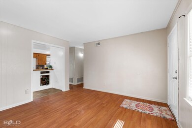Unfurnished living room with hardwood / wood-style