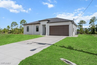 Prairie-style home with stucco siding, driveway, a