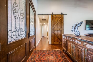 Foyer with hardwood / wood-style floors and a barn door