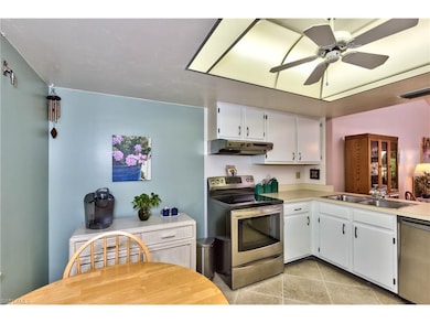 Kitchen offers diagonally laid tile, eat in kitche
