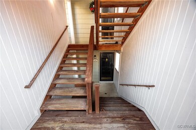 Staircase featuring wood walls