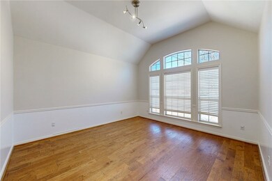 Spare room with hardwood / wood-style floors, loft