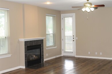 Unfurnished living room with ceiling fan, wood fi