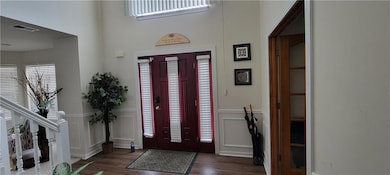 Entrance foyer with dark hardwood / wood-style flo