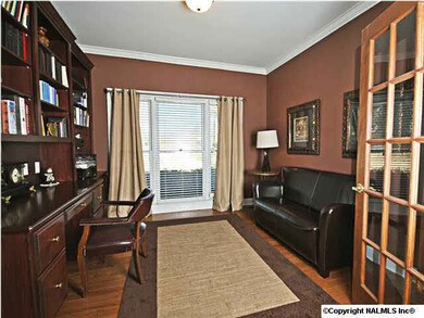 Study in front of home has desk with built ins