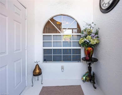 Property entrance with stucco siding