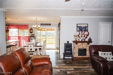 Living room featuring crown molding, dark wood-typ