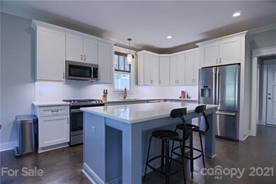 Gleaming Quartz countertops in kitchen and stainle