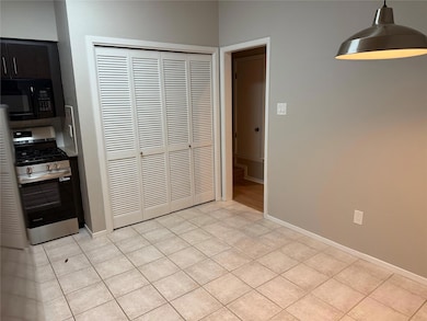 Unfurnished dining area featuring light tile patt