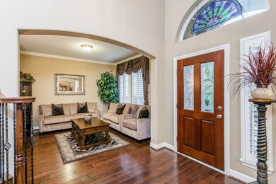 To the right as you enter is the formal living area, which could also easily serve as a study or at-home workspace.  A wall of windows looks out towards the front yard and the hardwood floors offer added character to the space.