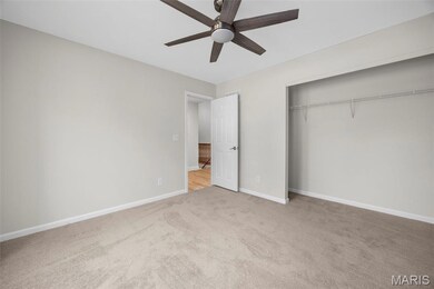 Unfurnished bedroom with light carpet, a ceiling fan, and a closet